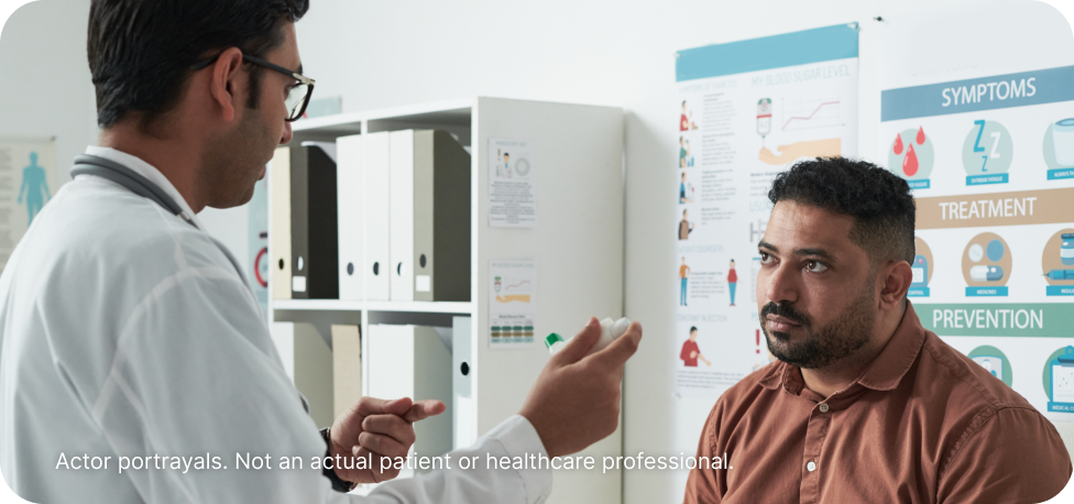 Actor portrayal of a doctor and patient discussing triglyceride levels in a doctor's office.